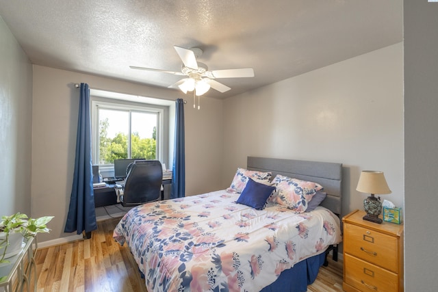 485 NW Thomas St, Pullman, WA 99163 - bedroom with light wood-style flooring, a ceiling fan, and baseboards