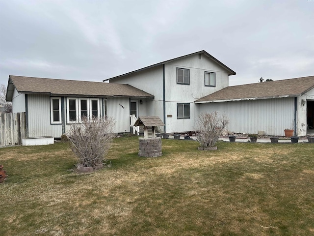 rear view of house featuring a yard