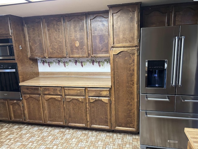 kitchen featuring stainless steel appliances and dark brown cabinetry