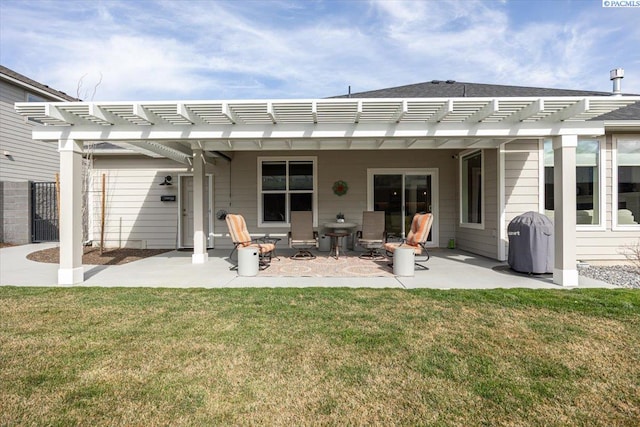 rear view of house with a patio, a pergola, and a yard