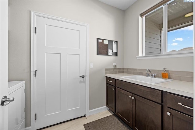 bathroom featuring vanity and baseboards