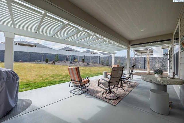 view of patio featuring a fenced backyard, grilling area, and a pergola