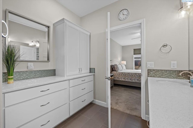 full bathroom featuring ensuite bathroom, tile patterned flooring, vanity, and baseboards