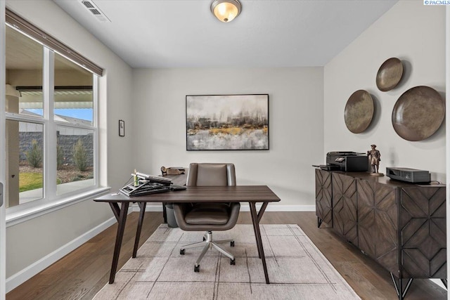 office with visible vents, baseboards, and wood finished floors