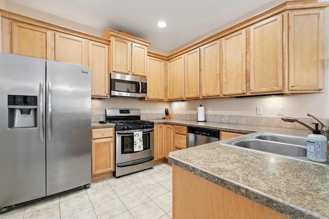 kitchen with sink, light brown cabinets, stainless steel appliances, and light tile patterned flooring