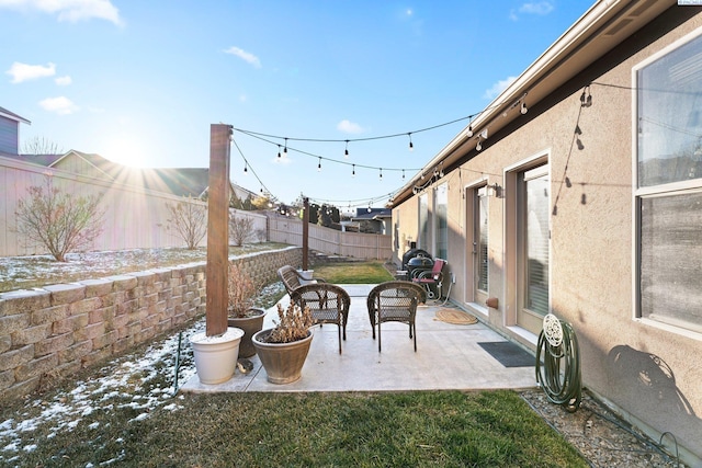 snow covered patio featuring a yard