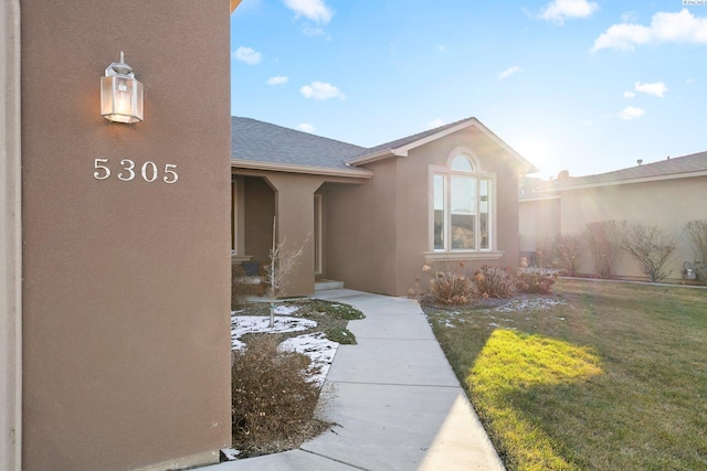 property entrance with a yard