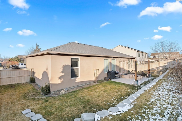 rear view of house featuring a patio and a yard