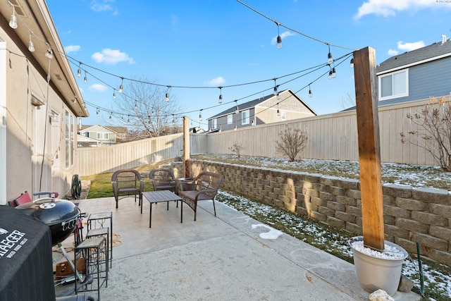 snow covered patio featuring grilling area