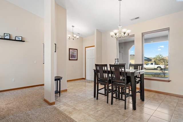 tiled dining area featuring a notable chandelier