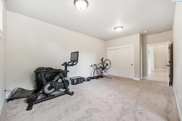 workout area featuring light colored carpet