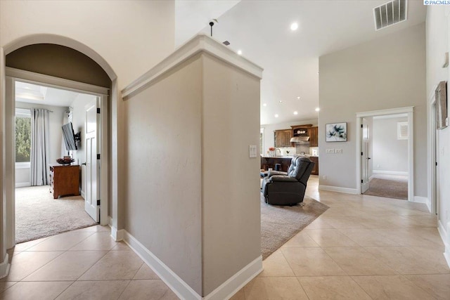 hall featuring light tile patterned flooring