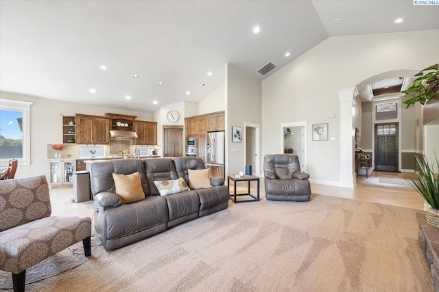 living room with high vaulted ceiling