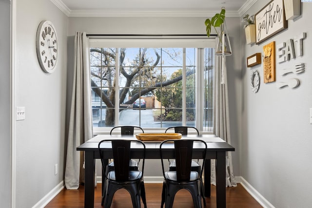 dining area featuring crown molding, baseboards, and dark wood-type flooring