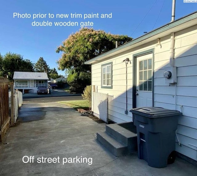 exterior space featuring entry steps and fence