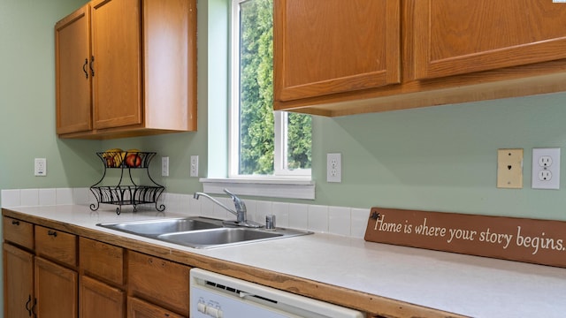 505 Armas Ct, Grandview, WA 98930 - kitchen with white dishwasher, light countertops, a sink, and brown cabinets
