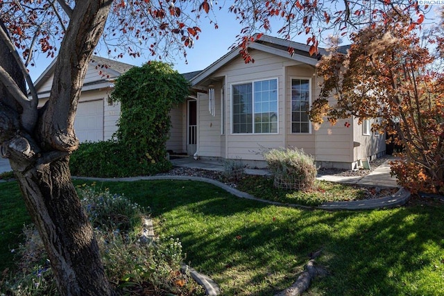 view of front of house with a garage and a front lawn