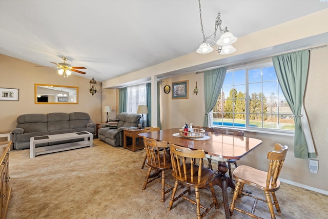 carpeted dining area featuring lofted ceiling and ceiling fan