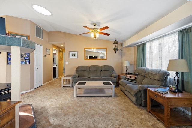 carpeted living room with ceiling fan and lofted ceiling