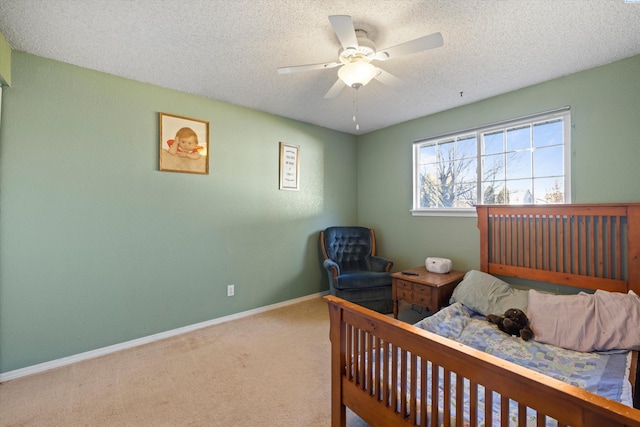 bedroom with ceiling fan, a textured ceiling, and carpet