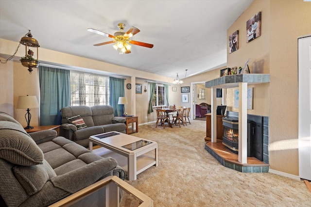 living room with vaulted ceiling, carpet, a fireplace, and ceiling fan