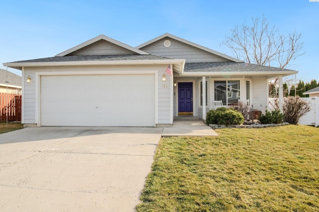 ranch-style home featuring a front lawn, fence, covered porch, concrete driveway, and an attached garage