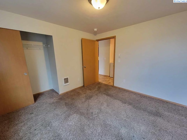 unfurnished bedroom featuring carpet floors and a closet