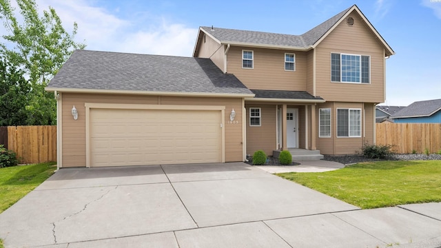traditional home with a garage and concrete driveway