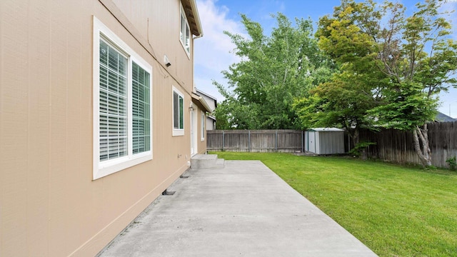 view of yard with a storage shed, a patio, and an outdoor structure