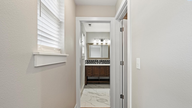 corridor featuring marble finish floors