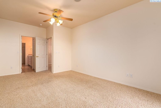 unfurnished room featuring baseboards, a ceiling fan, and light colored carpet