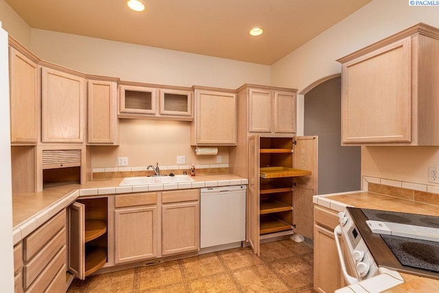 kitchen with arched walkways, open shelves, light brown cabinetry, a sink, and white appliances