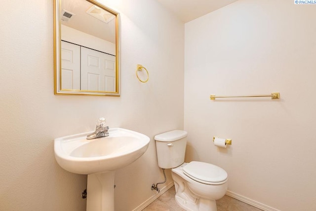 bathroom featuring toilet, baseboards, visible vents, and tile patterned floors