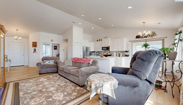 1609 Diamond Ave, Grandview, WA 98930 - living room with a chandelier, light wood-style flooring, vaulted ceiling, and recessed lighting