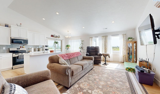1609 Diamond Ave, Grandview, WA 98930 - living room with vaulted ceiling, a chandelier, light wood-style flooring, and recessed lighting