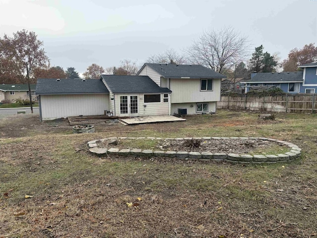 back of house with a patio, a yard, and central AC