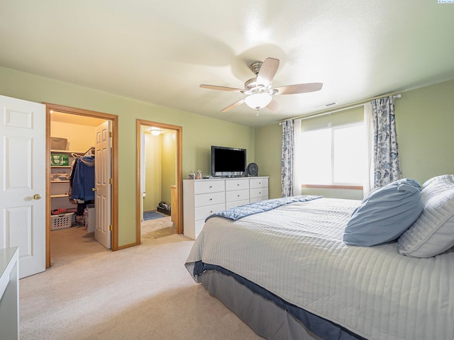 612 S Young St, Kennewick, WA 99336 - bedroom featuring light carpet, a walk in closet, a closet, ceiling fan, and ensuite bathroom