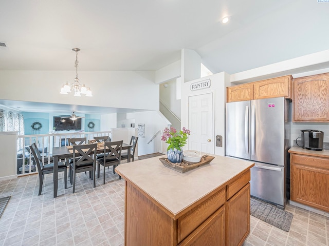 612 S Young St, Kennewick, WA 99336 - kitchen featuring freestanding refrigerator, vaulted ceiling, a chandelier, a center island, and light countertops