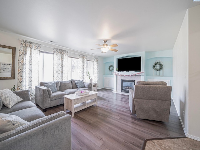 612 S Young St, Kennewick, WA 99336 - living area featuring a ceiling fan, a fireplace with flush hearth, wood finished floors, and baseboards