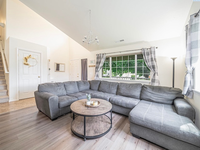 612 S Young St, Kennewick, WA 99336 - living room with high vaulted ceiling, a chandelier, stairs, and light wood-style floors