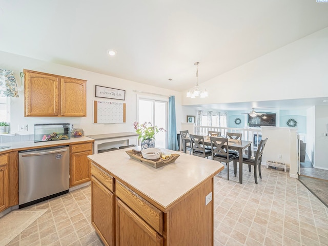 612 S Young St, Kennewick, WA 99336 - kitchen featuring stainless steel dishwasher, vaulted ceiling, light countertops, a chandelier, and a kitchen island