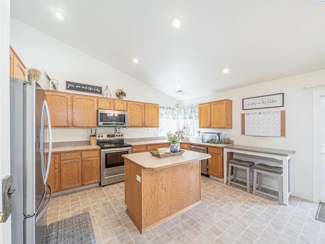 612 S Young St, Kennewick, WA 99336 - kitchen featuring appliances with stainless steel finishes, light countertops, vaulted ceiling, a kitchen island, and recessed lighting