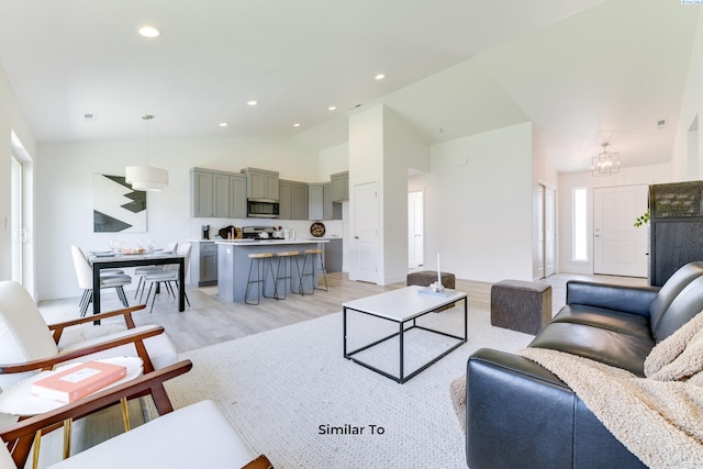 6665 W 29th Ct, Kennewick, WA 99338 - living area with light wood-style floors, recessed lighting, high vaulted ceiling, and a chandelier