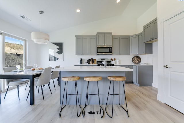 6665 W 29th Ct, Kennewick, WA 99338 - kitchen with stainless steel microwave, gray cabinetry, range, light countertops, and recessed lighting