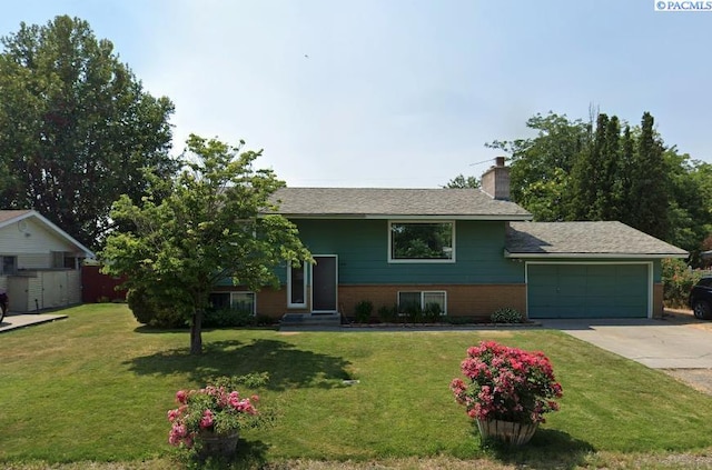 view of front of house with a garage and a front lawn