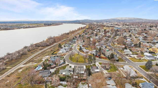 drone / aerial view featuring a water and mountain view