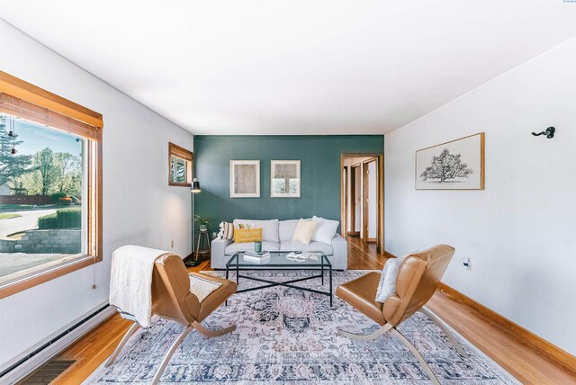 1830 Hunt Pt, Richland, WA 99354 - living room with a baseboard radiator, wood finished floors, and baseboards