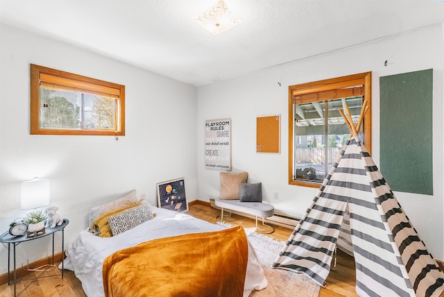 1830 Hunt Pt, Richland, WA 99354 - bedroom featuring multiple windows, wood finished floors, and baseboards