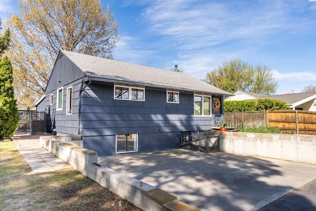 1830 Hunt Pt, Richland, WA 99354 - back of property featuring fence, a shingled roof, a patio area, and a gate