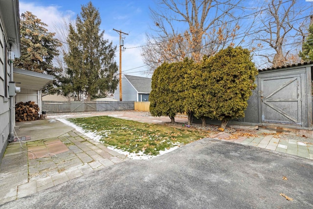 1830 Hunt Pt, Richland, WA 99354 - fenced backyard with a patio area, a storage unit, and an outbuilding